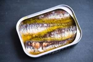Healthy Mediterranean sardine sandwich with arugula and lemon on toasted bread